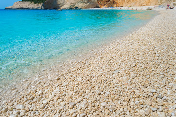Obraz premium A pebble beach with turquoise waters. Summer holidays concept.