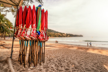multiple umbrellas on a beach for tourists before opening