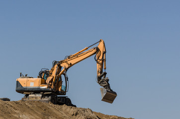 EXCAVATOR - The vehicle at work on construction site