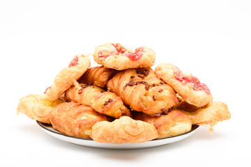 Pile of variety mini danish pastries in a plate isolated on white background.