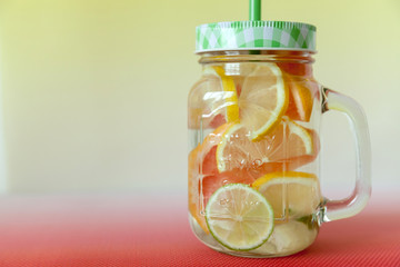 Homemade citrus lemonade in a glass jar, Cinco de Mayo celebration concept with copy space on the left