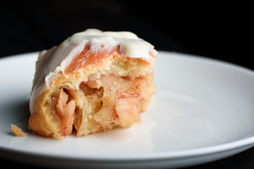 Sweet buns with a block and cinnamon on a dark background