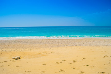 Fototapeta na wymiar Crystal clear turquoise sea waters of a pebble beach. Kathisma beach in Lefkada ionian island in Greece
