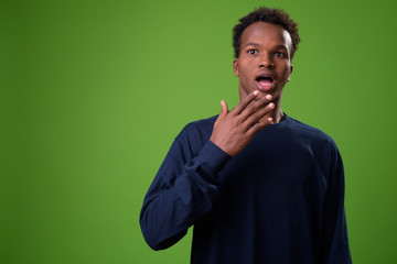Young African man against green background