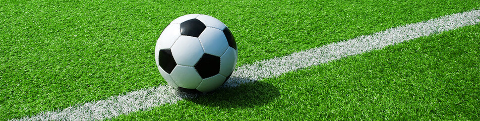 Fussball auf grünem Boden bei der Seitenlinie, als Banner im Querformat
