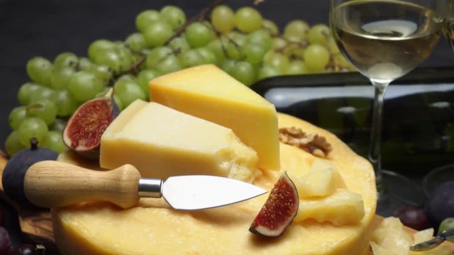 Video Whole round Head of parmesan or parmigiano hard cheese, grapes and wine