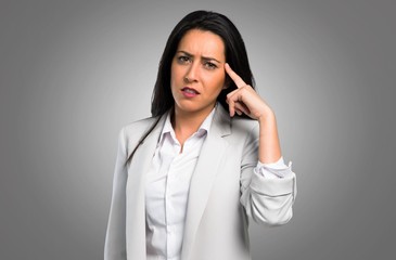 Pretty woman making crazy gesture on grey background