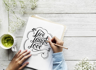 An artist creating hand lettering artwork from motivation quote