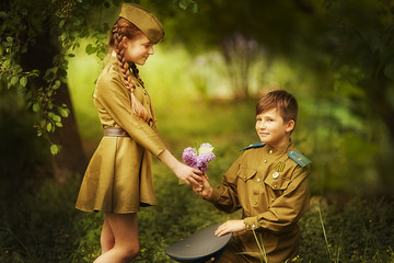 Fototapeta premium Boy with a girl in military uniform.day of victory