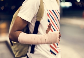 Injured young man with arm support
