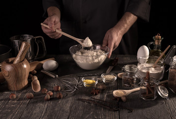 Fototapeta na wymiar Hands of pastry chef at work, set of ingredients for baking, isolated on black