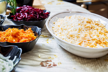 preparing russian traditional salad 'herring under fur coat'