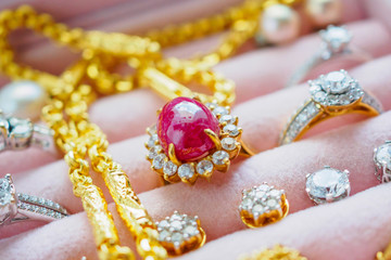 Gold and silver diamond gemstone sapphire ring necklaces and pearl earrings in luxury jewelry box