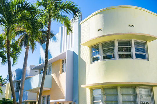Detail of typical Art Deco architecture with palm trees and blue sky in South Beach, Miami, Florida