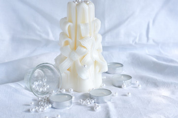 candle, white beads and glass bowl