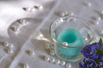 candle, white beads and shade from glass bowl