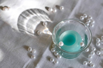 candle, white beads and shade from glass bowl