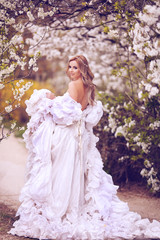 Candid skipping carefree adorable woman in field with flowers at summer sunset.