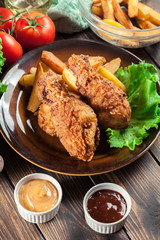 Crispy fried kentucky chicken legs with french fries