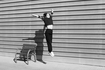 Black and white snapshot freezing the movement of a contemporary dance dancer in an urban setting