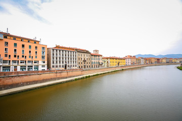 Fototapeta premium Old residential architecture with river Arno in Pisa, Italy.