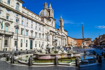 Fototapeta premium Fountain of the four Rivers with Egyptian obelisk, in the middle of Piazza Navona in Rome, Italy, with Sant'Agnese in Agone church at the background