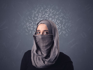 Young muslim woman wearing niqab with white alphabet letters above her head