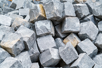 A pile of processed pieces of granite prepared for work on paving