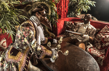 Actors in steam punk masks and antique costumes indoor.