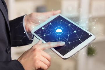 Business woman using tablet with financial, cloud connectivity concept