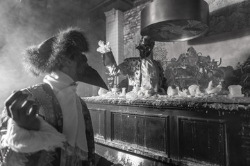 Actors in steam punk masks and antique costumes indoor. Black-white photo.