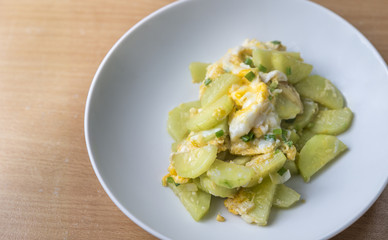 Healthy meal, stir fried vegetables or cucumber with chicken egg. Close up food.