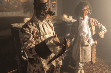 Actors in steam punk masks and antique costumes indoor.