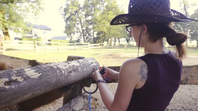 Cowgirl preparing fence for horses 4K