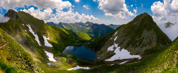 Panorama of Fagaras mountains of Romania. gorgeous landscape with glacier lake Capra, view from...