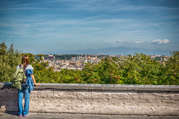 Woman in Janiculum promenade with Rome cityscape on the background
