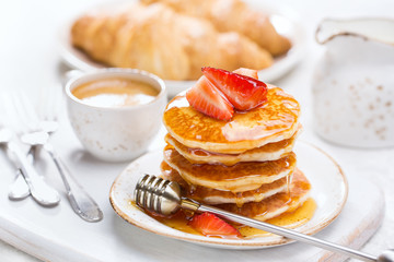 Homemade pancakes with fresh strawberries and honey Pancakes for Breakfast.