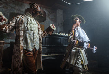 Actors in steam punk masks and antique costumes indoor.