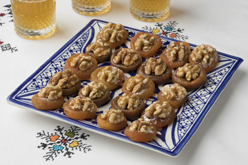 Dish with Moroccan dried apricots decorated with walnuts