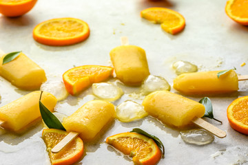 Orange popsicle with fresh oranges and ice, summer refreshing concept