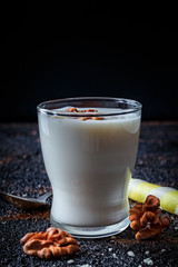 Layered greek yogurt parfait with nut and cornet in a glass. Healthy breakfast. Dark food photography. Close up, vertical