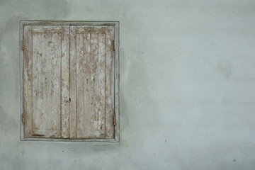 Old wooden window on gray wall with copy space