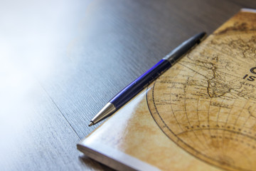 World map and pen on wooden table