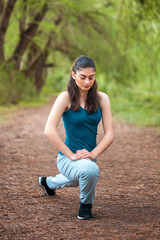 Beautifull sports girl in the park is engaged in fitness, warm-up