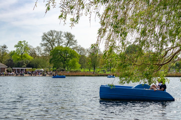 Paddling boats in a park lake in springtime