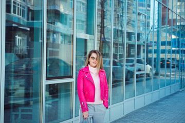 fashion girl pink leather jacket posing outdoors