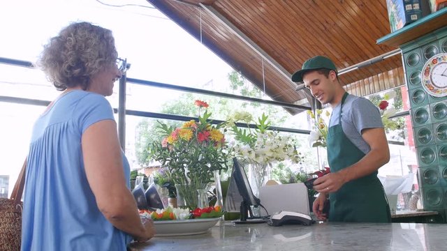 Senior woman buying plants at a nursery