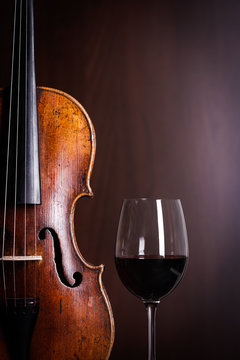 Violin waist detail with glass of wine