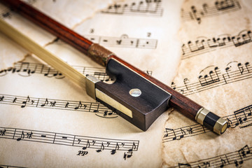 Violin bow on musical sheets