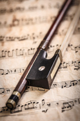 Violin bow on musical sheets
